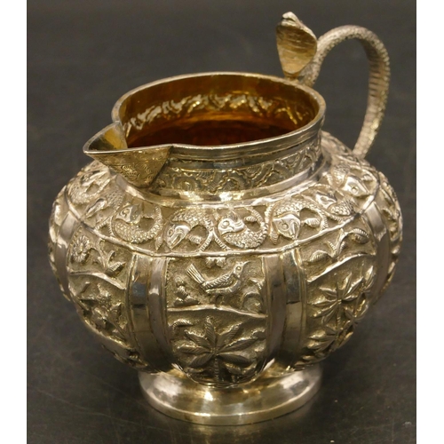 241 - An Eastern silver coloured metal round bulbous shaped milk jug with serpent shaped handle and allove... 