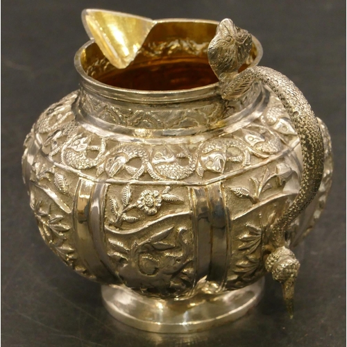 241 - An Eastern silver coloured metal round bulbous shaped milk jug with serpent shaped handle and allove... 