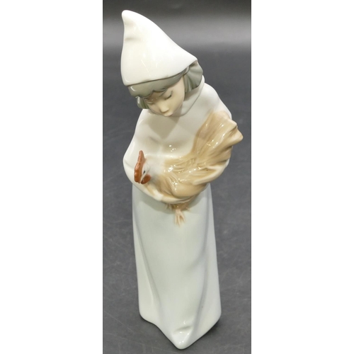 3 - A Lladro figure of a standing young girl holding a bird, 20cm high