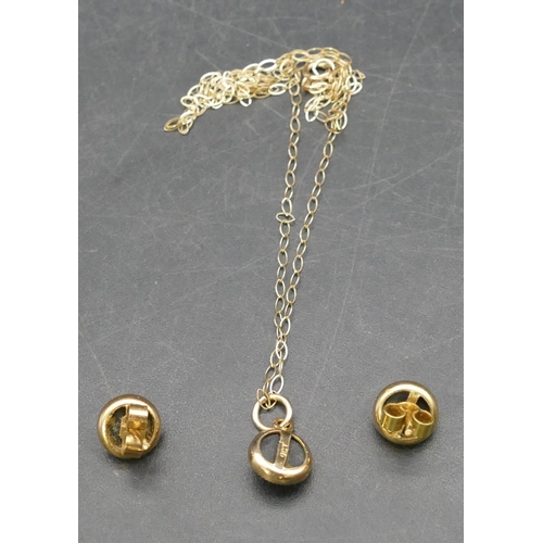 407 - A 9ct gold small black pendant with chain, also a pair of similar earrings, 1.6 grams gross,