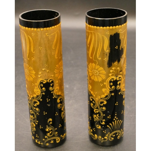 45 - A pair of black glass cylindrical vases with allover gilt decoration, 17cm high