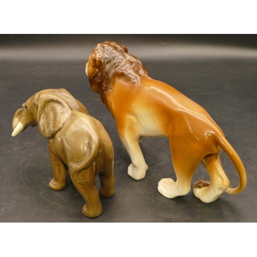 54 - A Royal Dux figure of a prowling lion, 22.5cm long and a china figure of an elephant, 9.5cm high