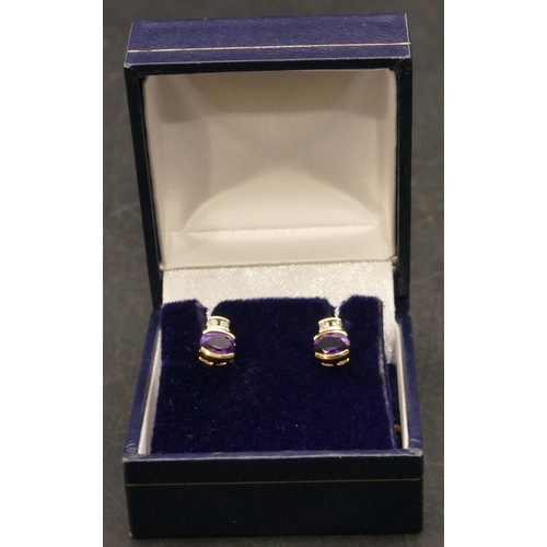 658 - A pair of 18ct gold stud earrings set with amethysts, each mounted with 2 small diamonds above, 1.6 ... 