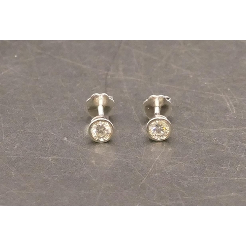 659 - A pair of 18ct white gold solitaire diamond earrings with screw backs, each diamond approx. 0.20ct, ... 