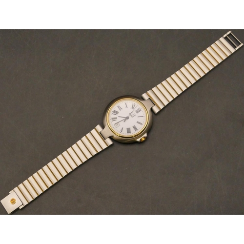 688 - A Dunhill Quartz steel wristwatch with white enamel dial, seconds hand and calendar, matching steel ... 