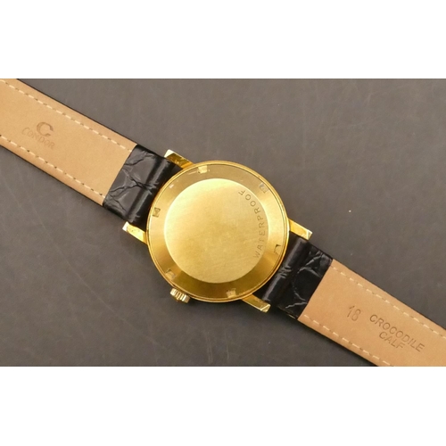 696 - An 18ct gold Omega Automatic Gent's circular wristwatch with seconds hand and calendar depicting por... 