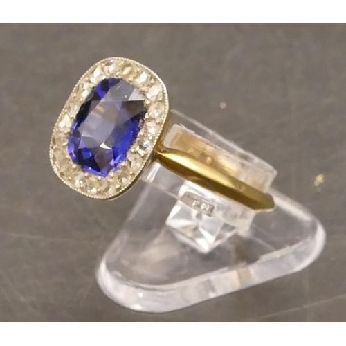 697 - An 18ct gold cluster ring set with centre blue stone surrounded by small diamonds, Size P/Q