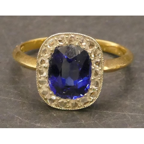 697 - An 18ct gold cluster ring set with centre blue stone surrounded by small diamonds, Size P/Q