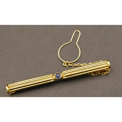 698 - An 18ct gold Cartier Tie clip set with centre sapphire, stamped and no. C69870, with safety chain, 6... 