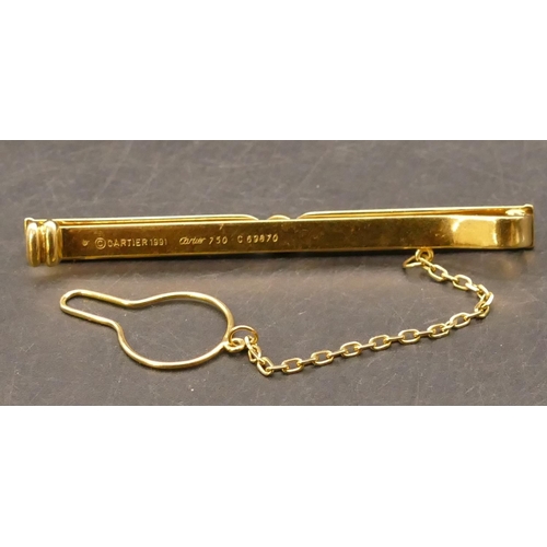 698 - An 18ct gold Cartier Tie clip set with centre sapphire, stamped and no. C69870, with safety chain, 6... 