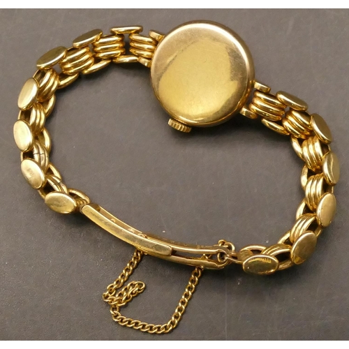 699 - A Tudor Royale ladies' circular 9ct gold wristwatch with matching strap bracelet, stamped 