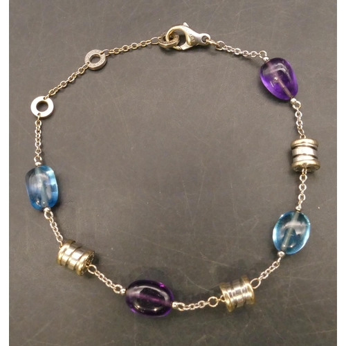 705 - An 18ct white gold Bulgari bracelet mounted with amethysts and blue topaz, 23.5cm long, 13.3 grams g... 