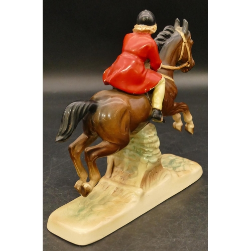 75 - A china figure of a girl on horseback jumping a fence, 18cm high (red coat paint flaking)