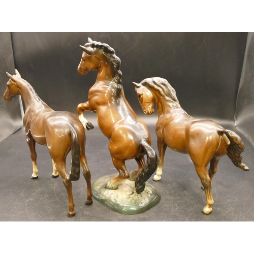 76 - A Beswick figure of a rearing horse 1014, 26cm high, and 2 Beswick figures of horses (3)