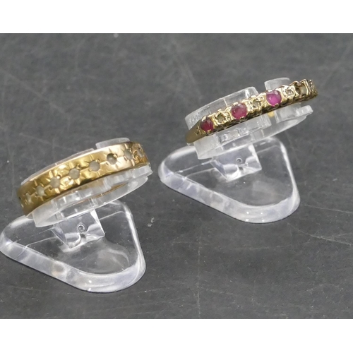 766 - A 9ct gold ladies' half eternity ring set with red stones and small diamond chips (2 red stones miss... 