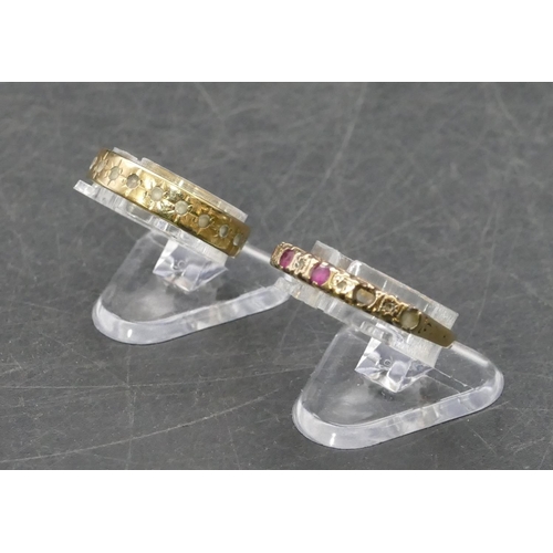 766 - A 9ct gold ladies' half eternity ring set with red stones and small diamond chips (2 red stones miss... 