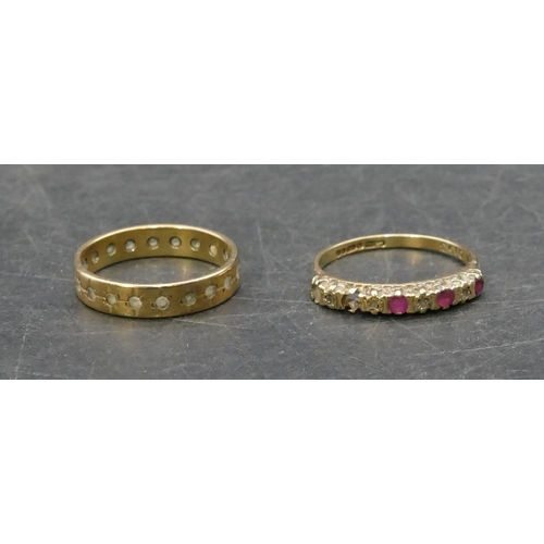 766 - A 9ct gold ladies' half eternity ring set with red stones and small diamond chips (2 red stones miss... 