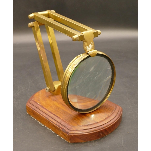 774 - A brass folding desk magnifying glass on later walnut base, 41cm high extended