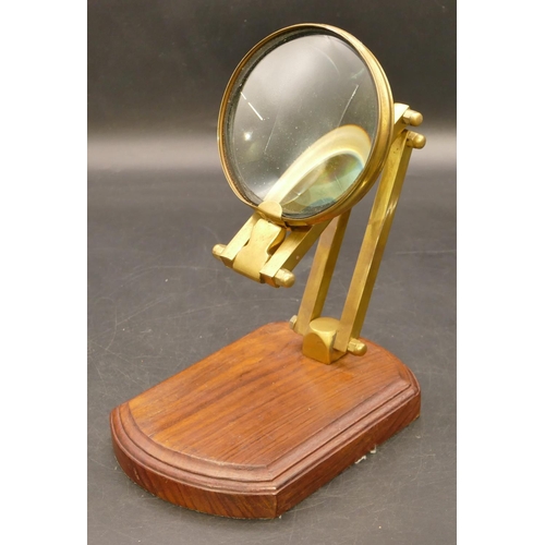 774 - A brass folding desk magnifying glass on later walnut base, 41cm high extended