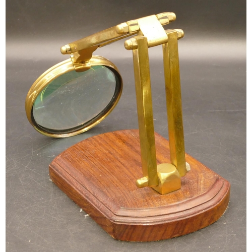 774 - A brass folding desk magnifying glass on later walnut base, 41cm high extended