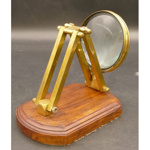 774 - A brass folding desk magnifying glass on later walnut base, 41cm high extended