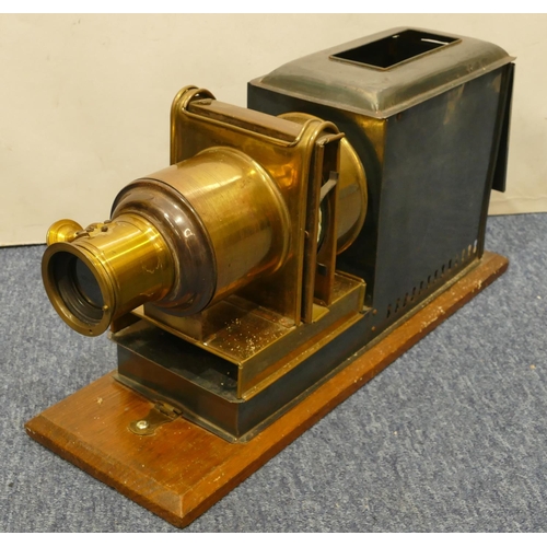 776 - A brass and metal magic lantern on wooden rectangular shaped based, 48cm long overall, 24.5cm high