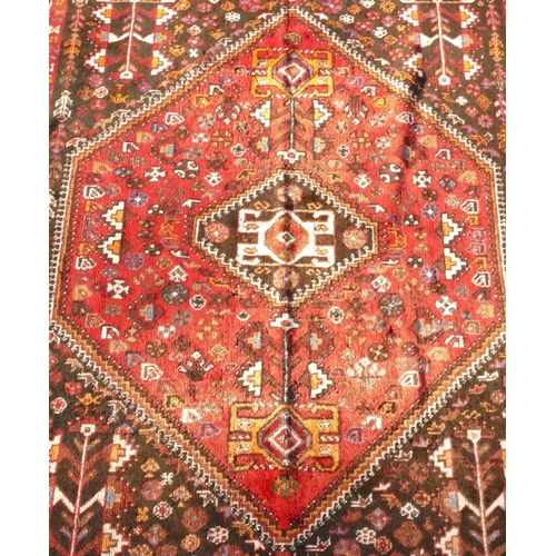 792 - A Persian small carpet on red ground with centre medallion, 255cm x 174cm (worn to 1 end)