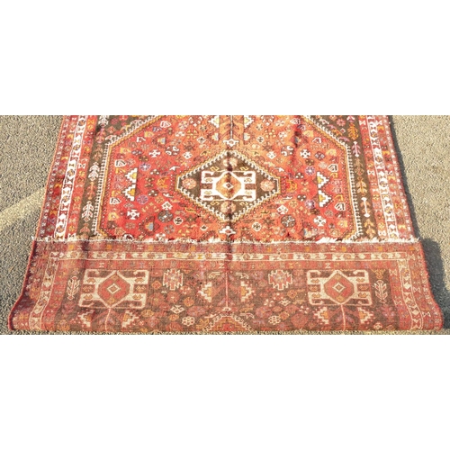 792 - A Persian small carpet on red ground with centre medallion, 255cm x 174cm (worn to 1 end)