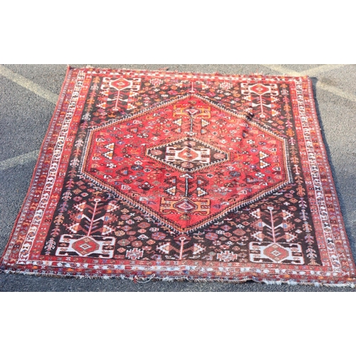 792 - A Persian small carpet on red ground with centre medallion, 255cm x 174cm (worn to 1 end)