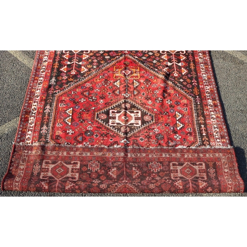 792 - A Persian small carpet on red ground with centre medallion, 255cm x 174cm (worn to 1 end)