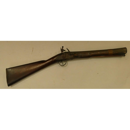 794 - A 19th Century mahogany flint lock Blunderbuss with ramrod  (seized mechanism), 73.5cm long