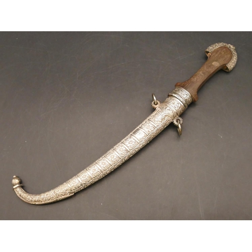 810 - A Middle Eastern dagger with silver coloured metal scabbard and mounts, wooden handle with embossed ... 