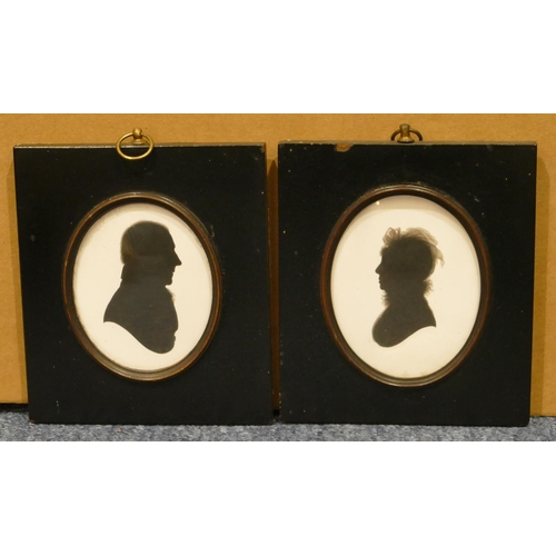 820 - A pair of black and white silhouettes, portrait of a gentleman and a lady, in black frames, 13cm x 1... 