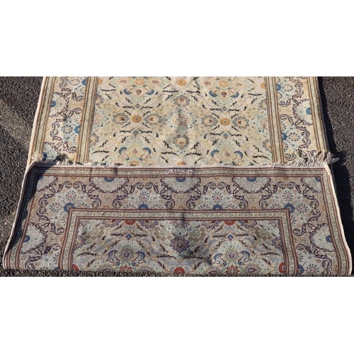 823 - A Persian rug on cream ground with multicoloured allover floral decoration, 218cm by 140cm