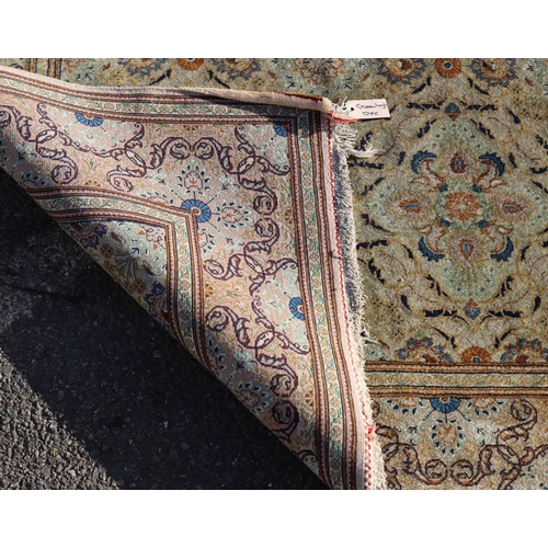 823 - A Persian rug on cream ground with multicoloured allover floral decoration, 218cm by 140cm