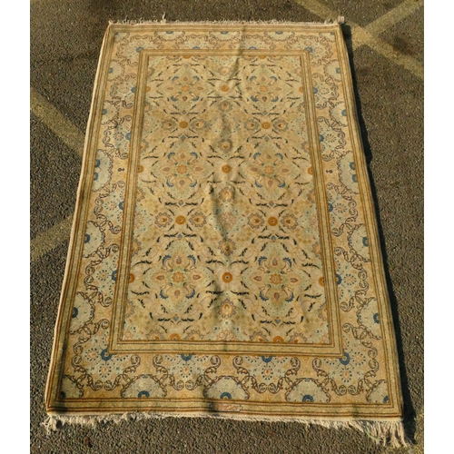 823 - A Persian rug on cream ground with multicoloured allover floral decoration, 218cm by 140cm