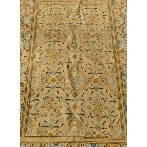 823 - A Persian rug on cream ground with multicoloured allover floral decoration, 218cm by 140cm