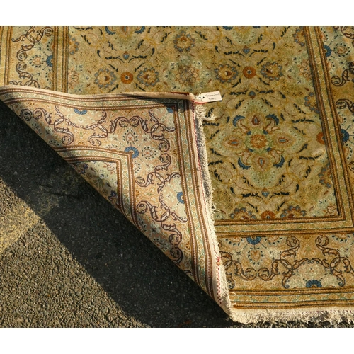 823 - A Persian rug on cream ground with multicoloured allover floral decoration, 218cm by 140cm