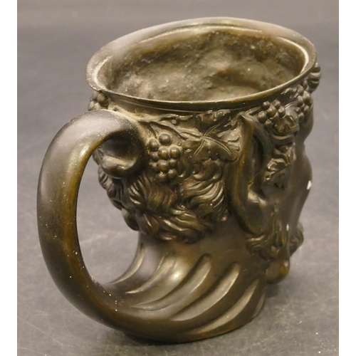 832 - A bronze cup in the form of a figurehead of a Bacchus, 9cm high