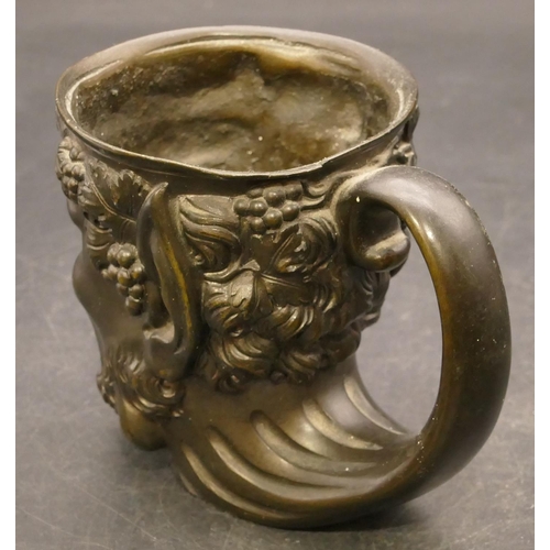 832 - A bronze cup in the form of a figurehead of a Bacchus, 9cm high