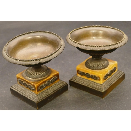 833 - A pair of small bronze urns on part marble square bases, 11cm diameter (stems slightly bent), 10cm h... 