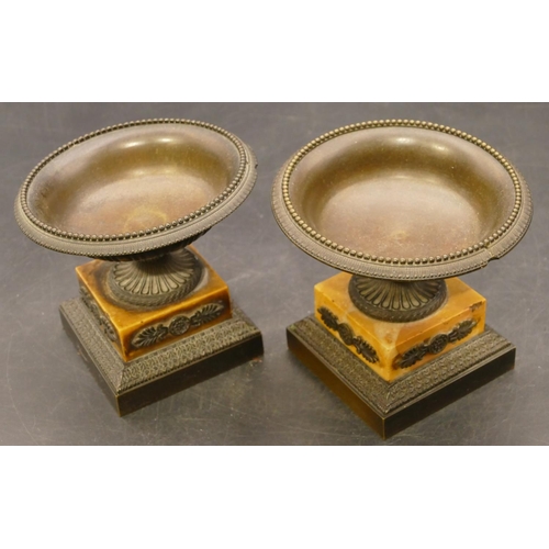 833 - A pair of small bronze urns on part marble square bases, 11cm diameter (stems slightly bent), 10cm h... 