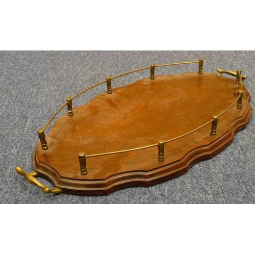 841 - A mahogany oval scallop shaped 2-handled tray with brass gallery and handles, 54.5cm wide