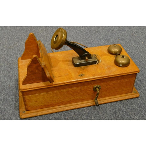 842 - A Western Electric Company American wall mounted oak telephone, 52cm high, 24cm wide (in need of res... 