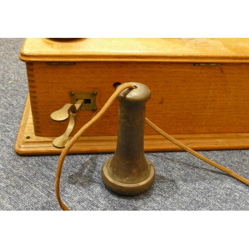 842 - A Western Electric Company American wall mounted oak telephone, 52cm high, 24cm wide (in need of res... 