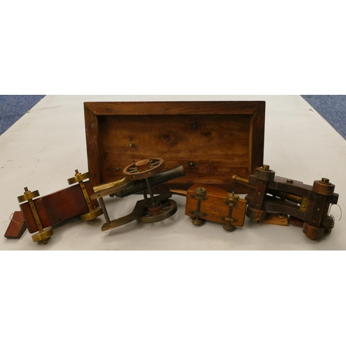 863 - 4 brass miniature table top cannons, largest 19cm long, a similar model of a cannon on a mahogany ba... 