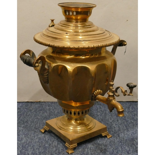 873 - A brass round bulbous 2-handled tea urn with tap on square base with splayed feet, 33cm high (top co... 