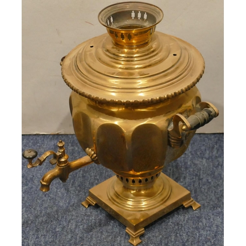 873 - A brass round bulbous 2-handled tea urn with tap on square base with splayed feet, 33cm high (top co... 