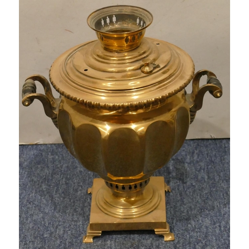 873 - A brass round bulbous 2-handled tea urn with tap on square base with splayed feet, 33cm high (top co... 