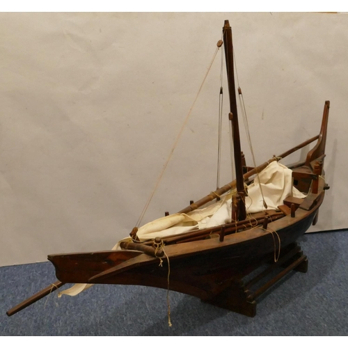 882 - A large model of a sailing boat, with stand, 130cm long